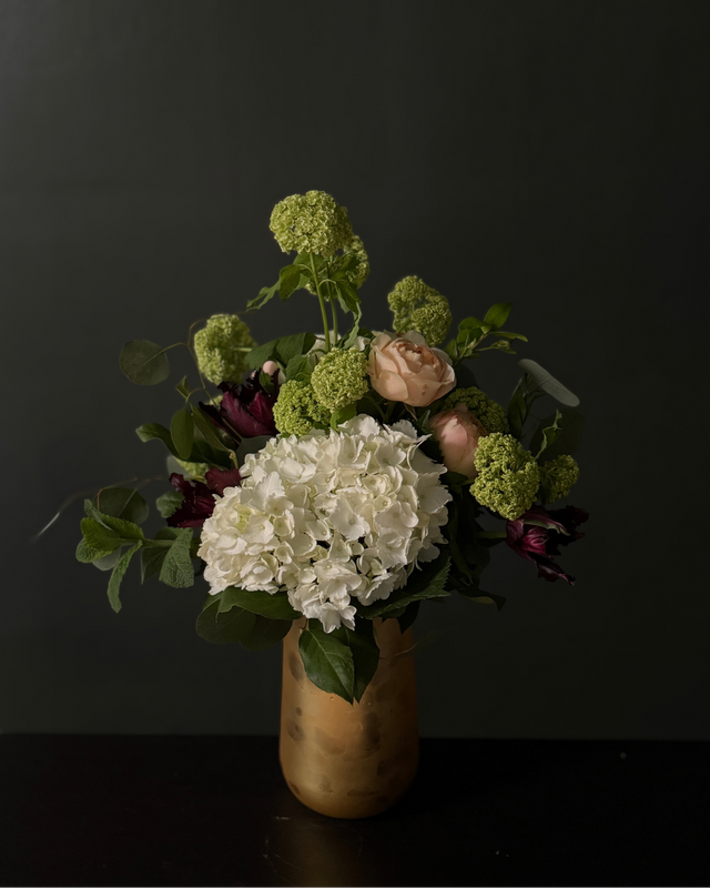 Bouquet of flowers in a vase against a dark background