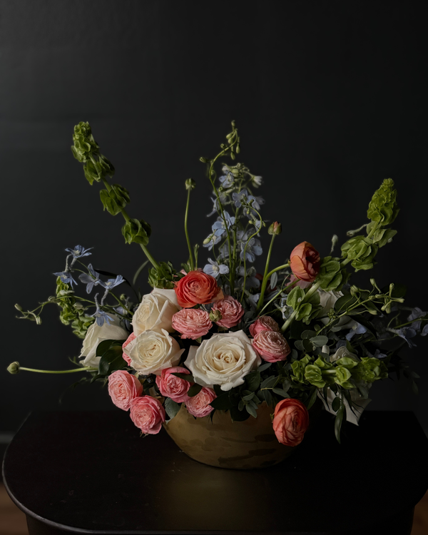 Bouquet of flowers in a vase against a dark background